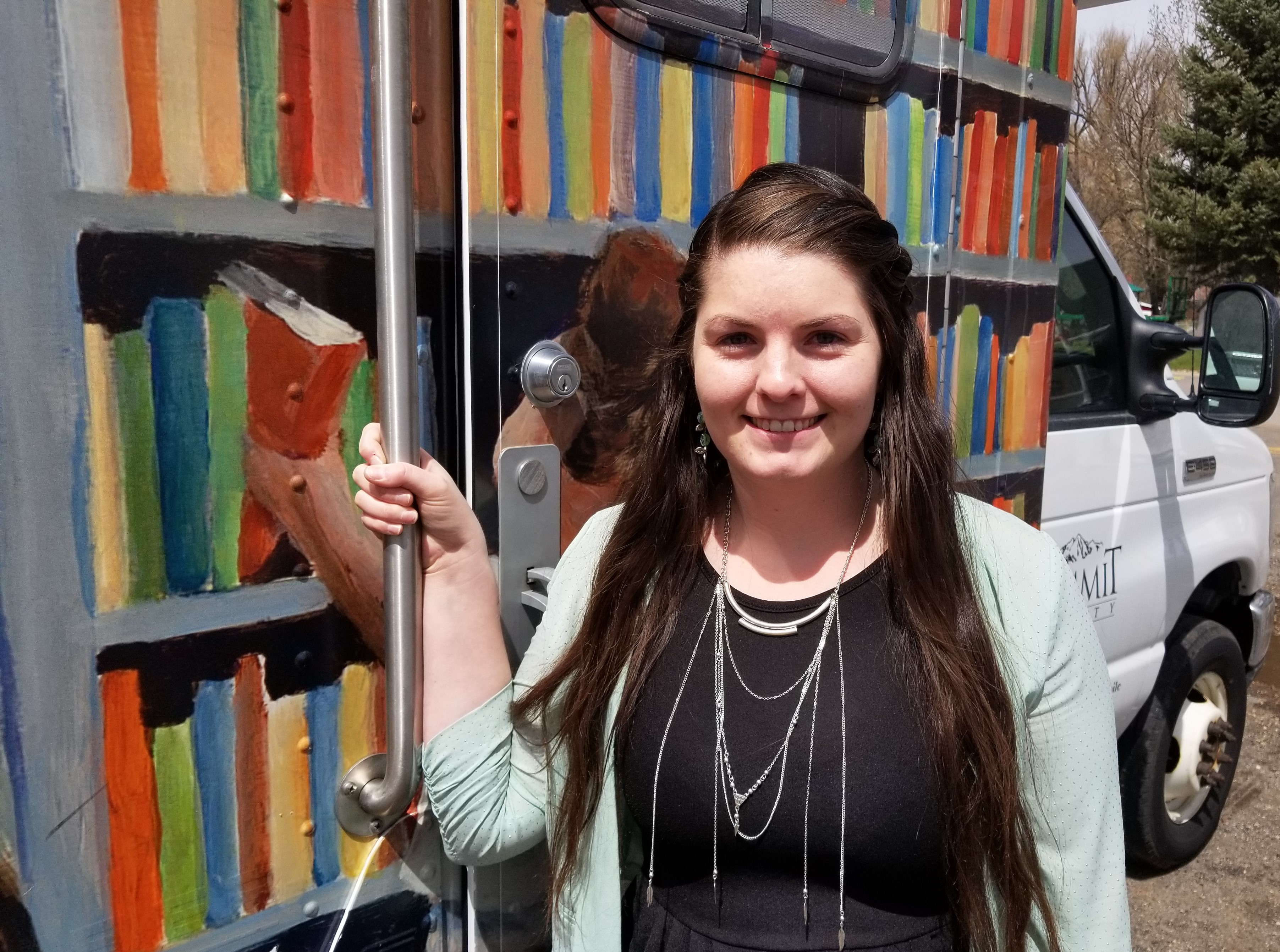 photo of Shaylee Phelps in front of the Bookmobile